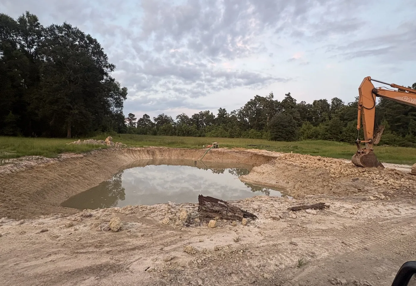 Excavator digging with its bucket on a job site near Hammond, LA